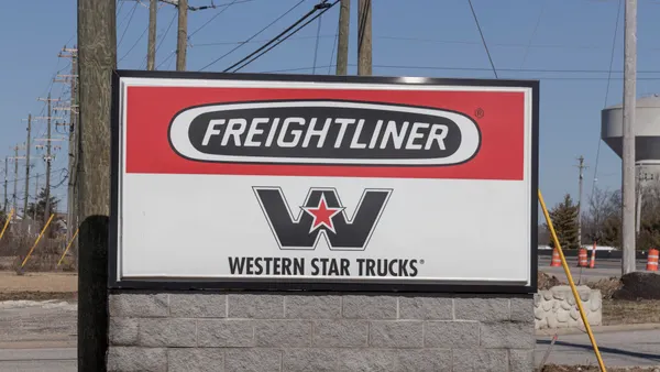 A sign shows Freightliner and Western Star logos.