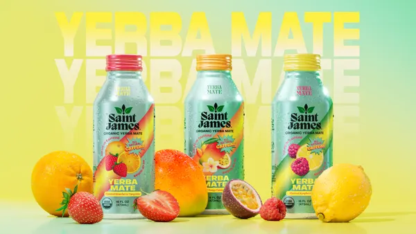 Three cans of Saint James' Yerba Mate tea next to fruit.
