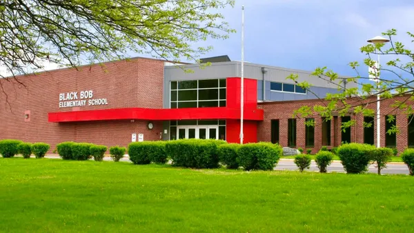 The exterior of an elementary school with a sign on the left brick wall that says "Black Bob Elementary School."