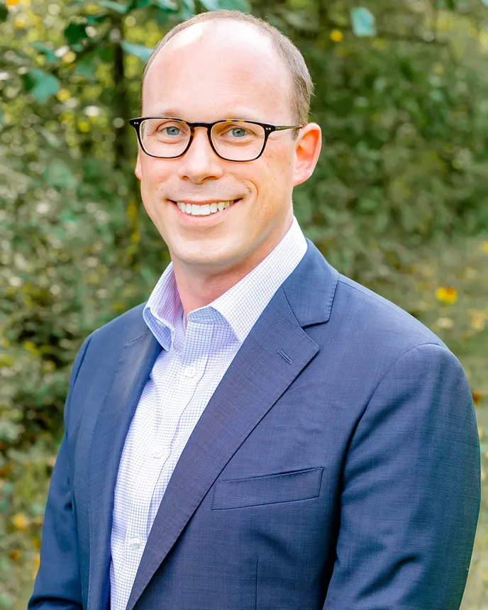 A professional headshot of Ted Fahey.