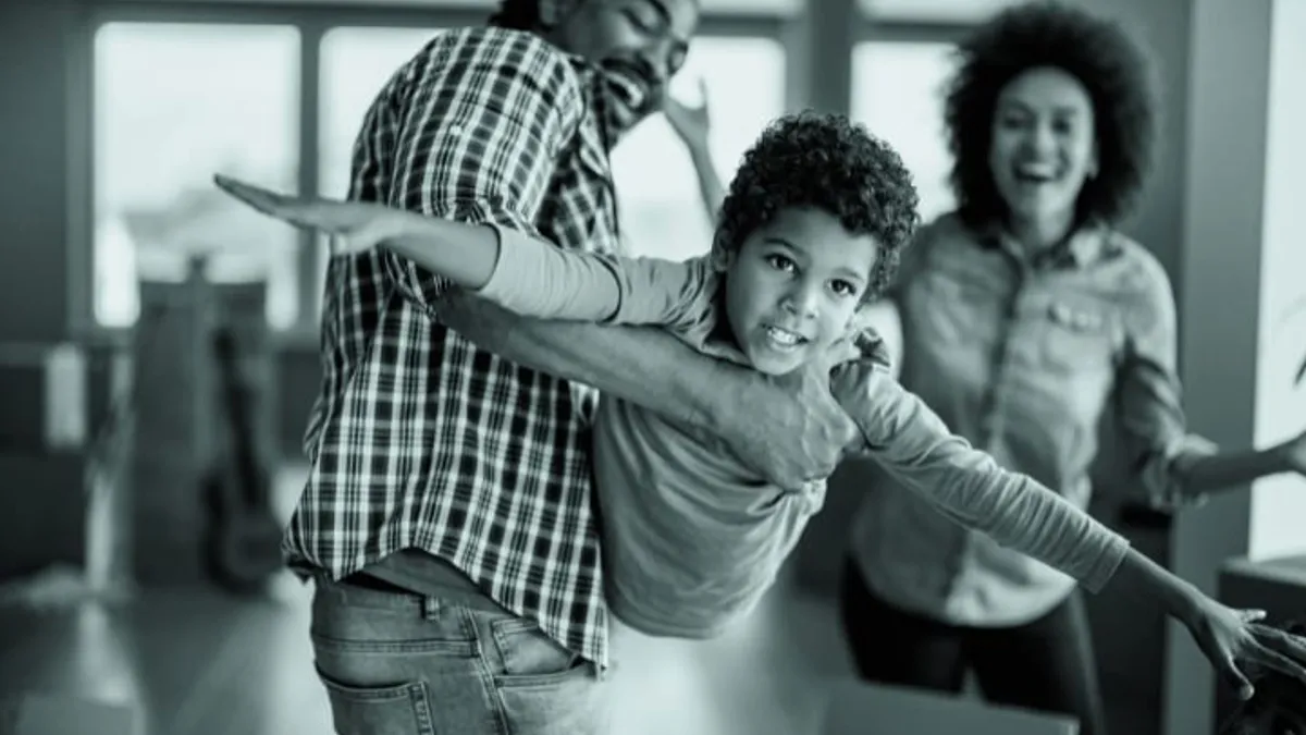 African American father playing with his son.