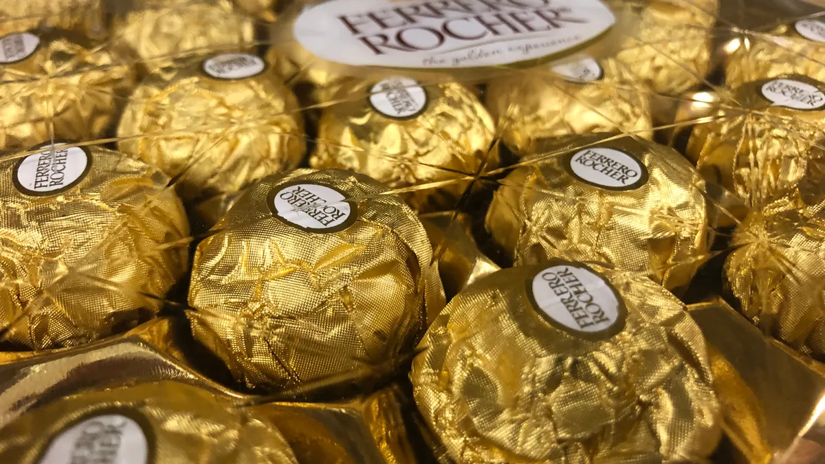 A bunch of Ferrero Rocher chocolate hazelnut candies in a display.