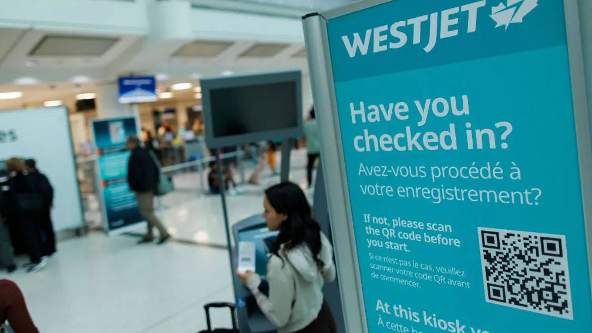 Westjet signage is seen at the Toronto Pearson International airport on June 30, 2024 in Toronto, Canada. The airline said some customer data was stolen during a June 2025 cyberattack.