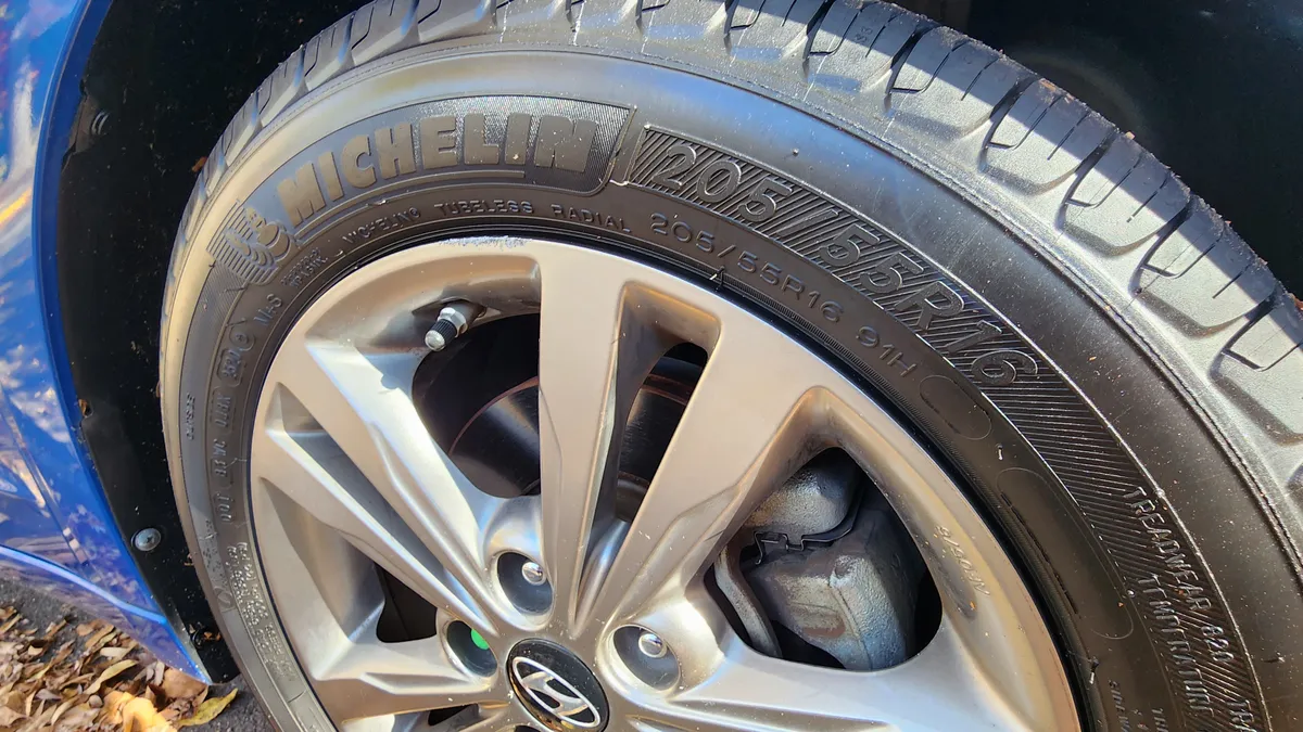 A Michelin tire on a blue car.