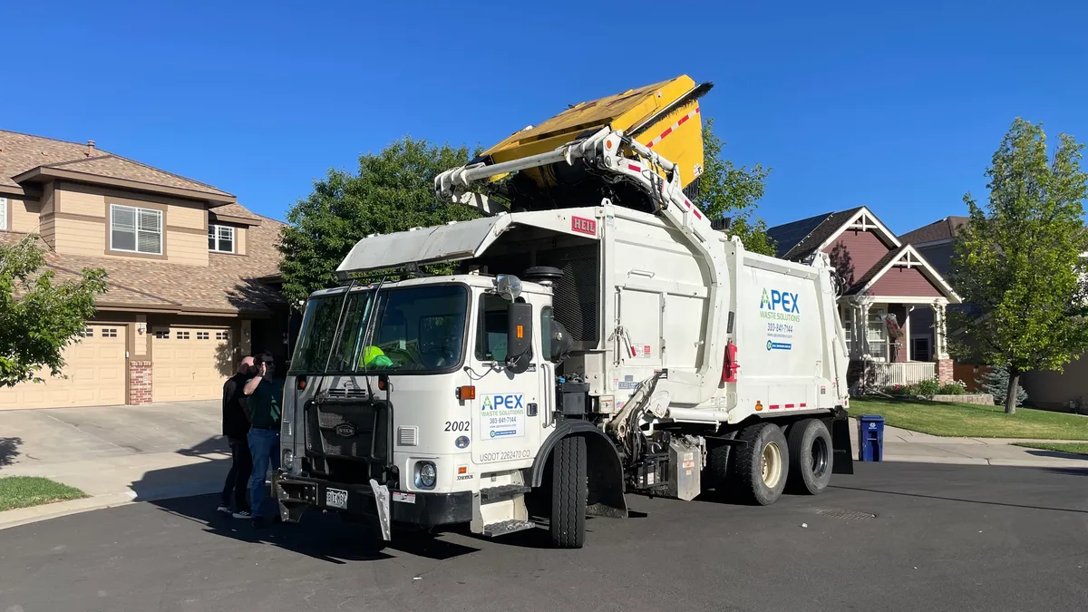 White Apex Waste Solutions truck on a residential street