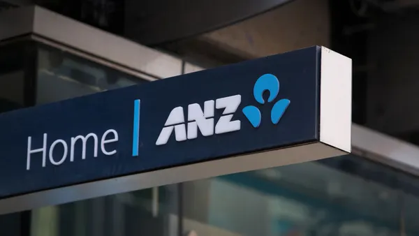 A blue sign with white letters reads "Home | ANZ" and the bank's logo