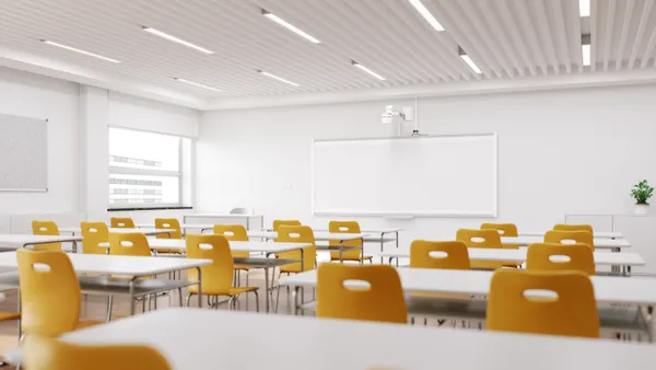 Rows of empty chairs in a modern-looking classroom.