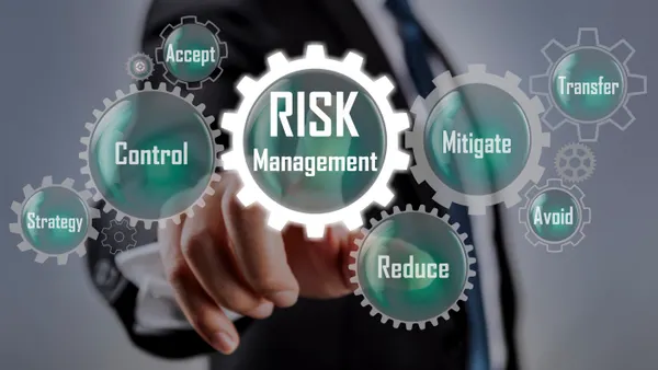 Businessman pointing at risk management concept on screen
