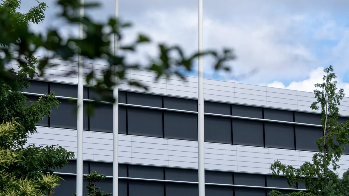 White flags bearing Novo Nordisk's logo are seen against a blue sky.