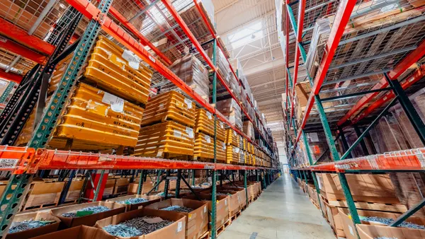A long aisle with stacked goods in a facility