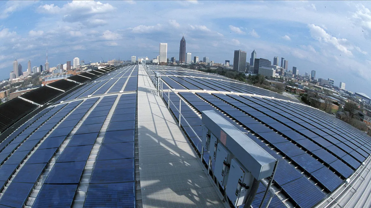 Solar panels on the Georgia Tech Aquatic Center, with Atlanta skyline in the distance