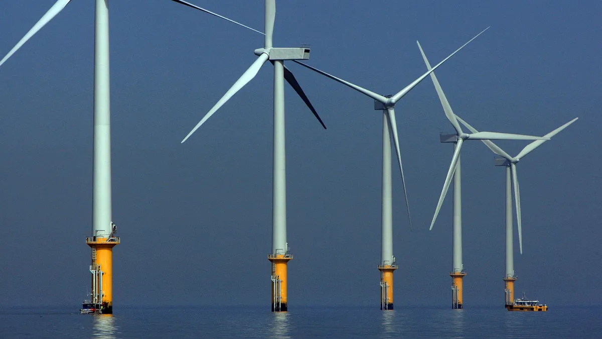 A maintenance boat works next to the turbines of the new Burbo Bank off shore wind farm in the mouth of the River Mersey on May 12, 2008 in Liverpool, England.