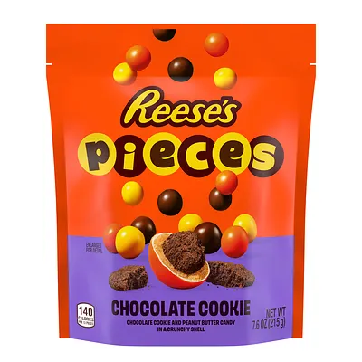 A photo of a bag of candy. The bag is orange and purple and says "Reese's Pieces chocolate cookie."