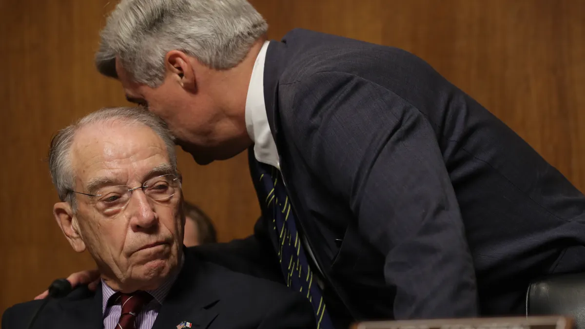 Sens. Charles Grassley (R-IA) and Sheldon Whitehouse (D-RI) talk during hearing meeting.