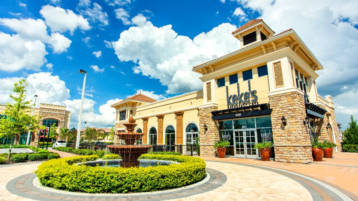 An image of a roundabout with a fountain outside a beige building with a sign that says Keke's Breakfast Cafe