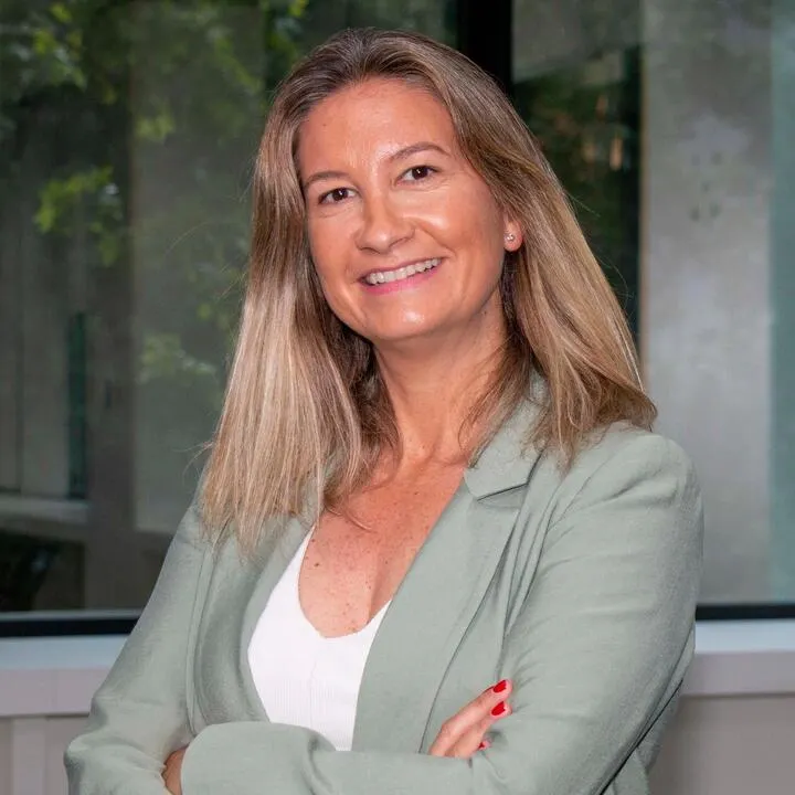 Headshot of a woman with long hair and a suit.