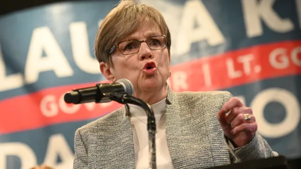 Kansas Gov. Laura Kelly speaks at a podium.