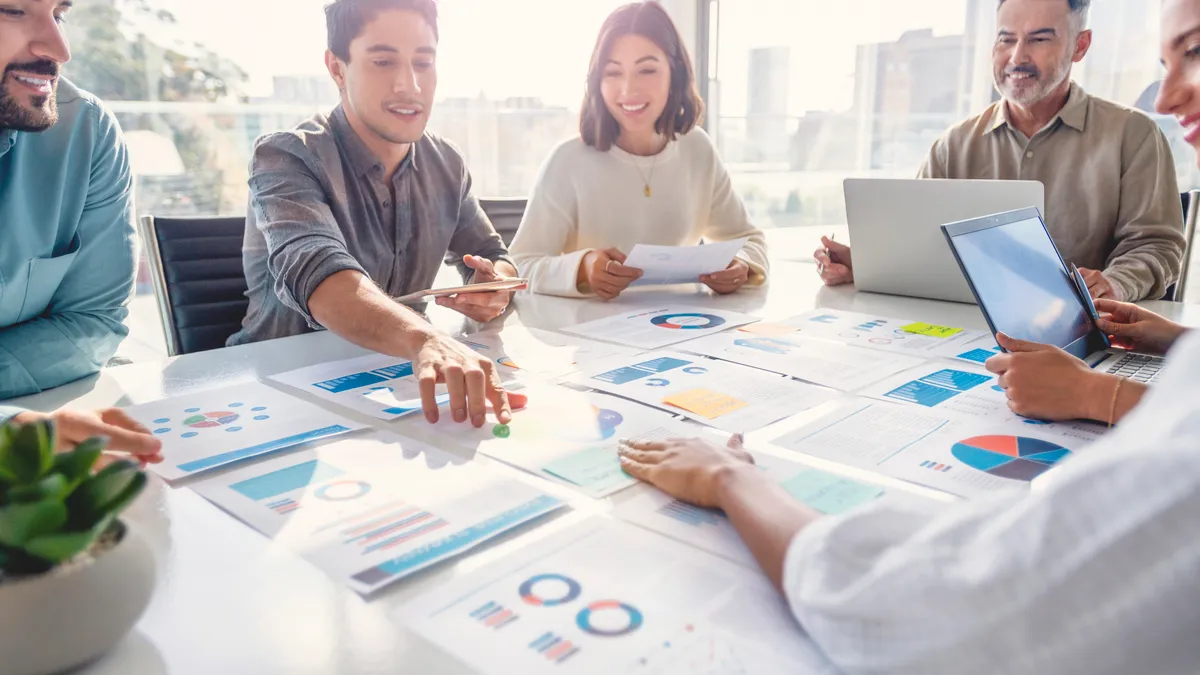 A group of workers sitting around a meeting room table