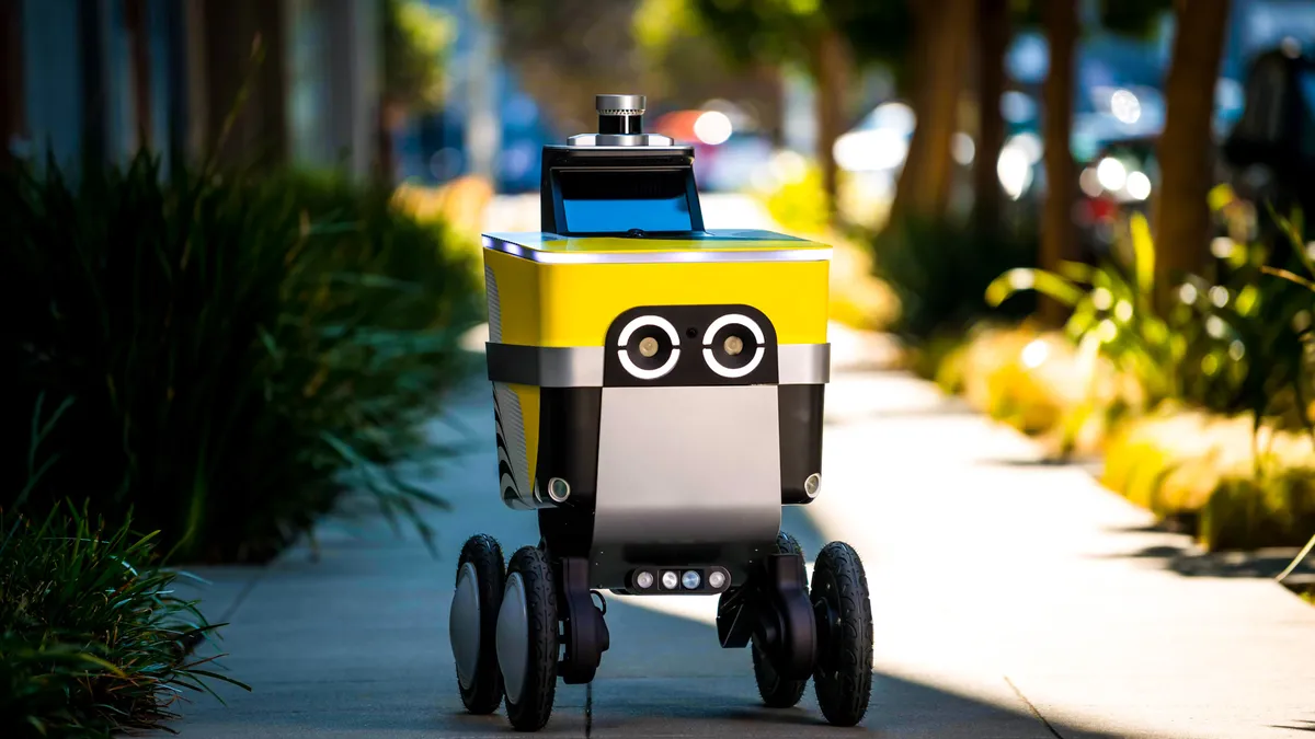 A photo of a Serve Robotics robot driving on a sidewalk.