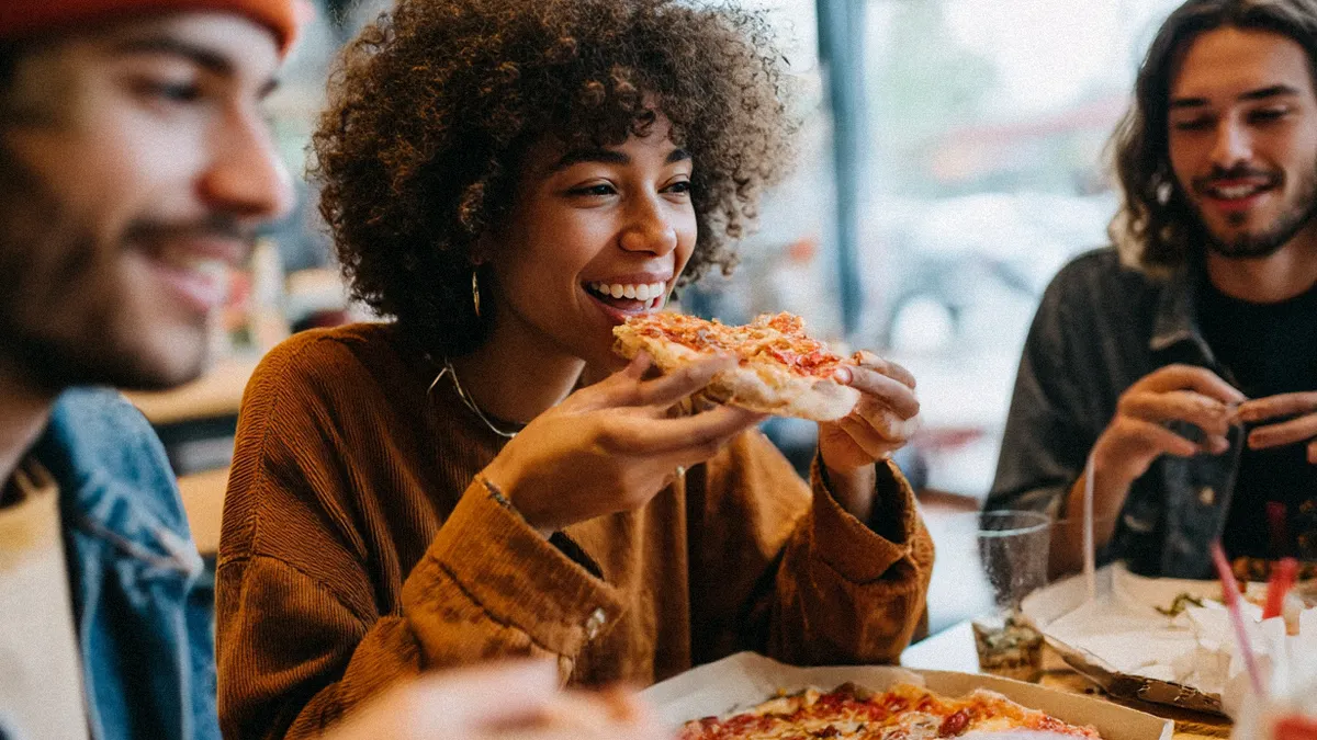 Happy diners eating pizza