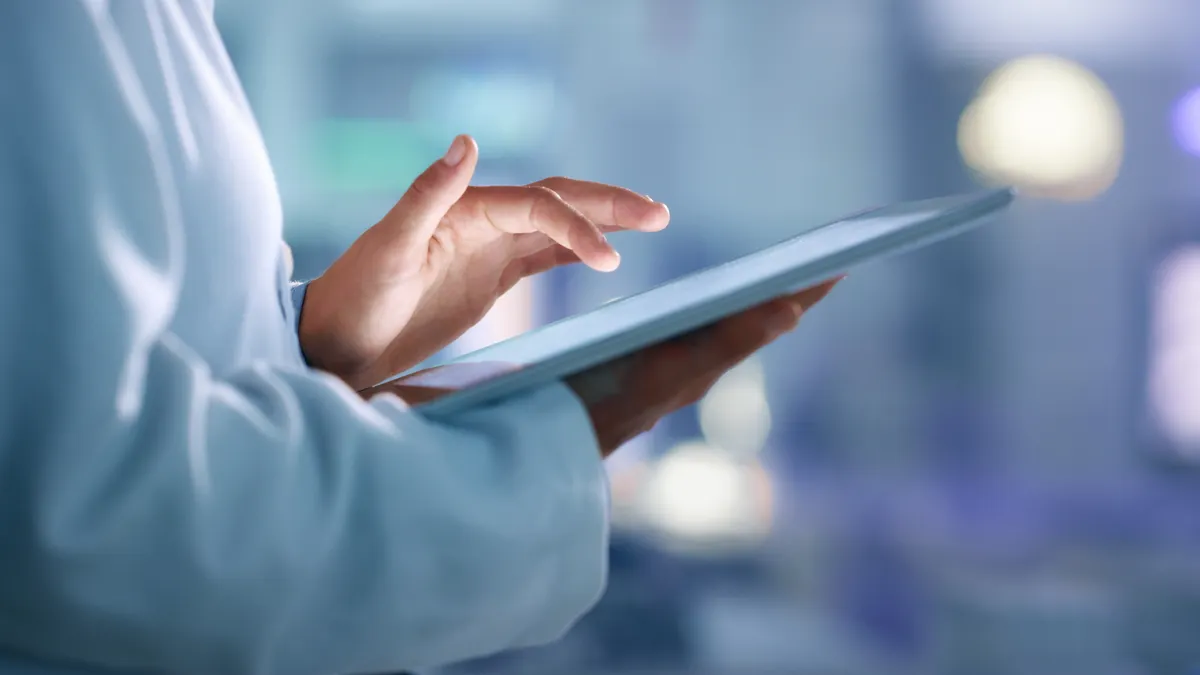Doctor, researcher or scientist browsing the internet on a tablet for information while working at a lab