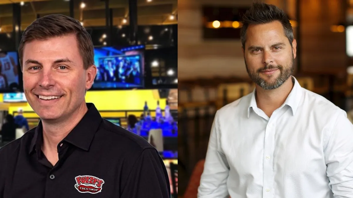 An image of two men smiling. The man on the left wears a black shirt with a "Fuzzy's Taco Shop" logo while the other wears a suit with a white undershirt.