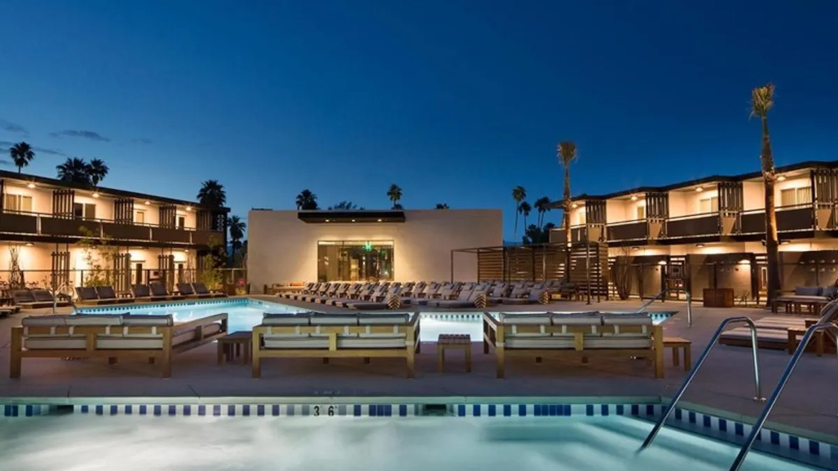 An image shows the outdoor pool at V Capri Palm Springs, a Dolce by Wyndham hotel in California.