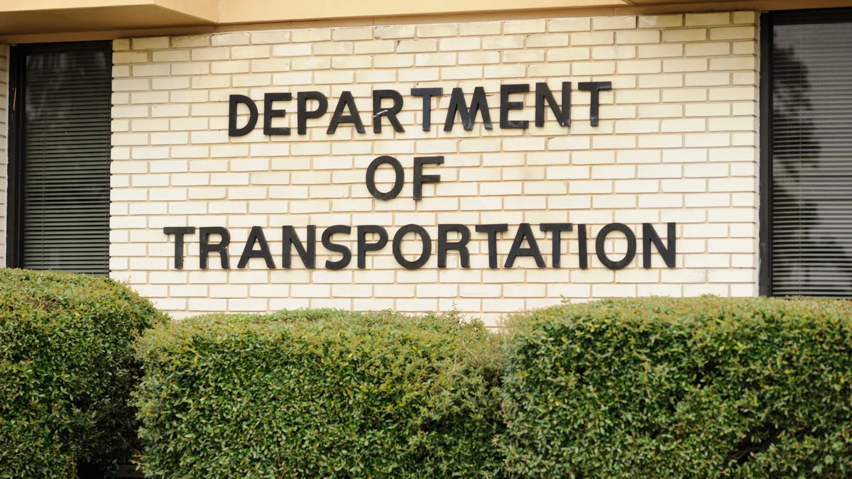 Close-up of building with Department of Transportation lettered on yellow bricks.