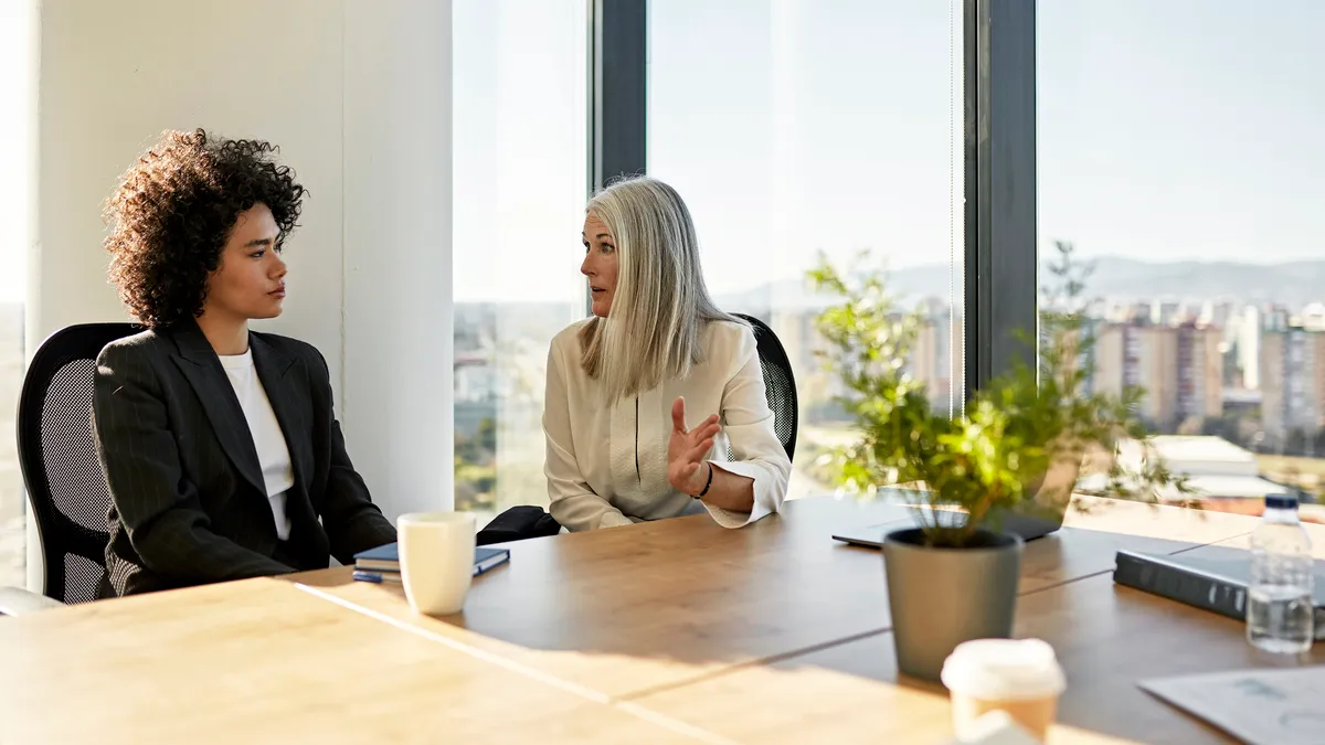 Businesswomen discussing ideas in corporate office