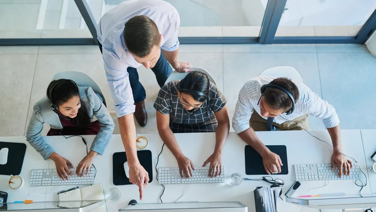 High angle shot of a person assisting colleagues at work