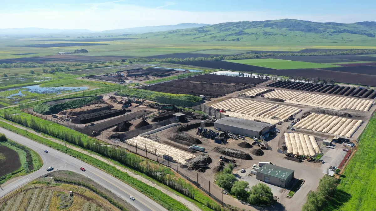 Aerial view of compost facility with mountains in background