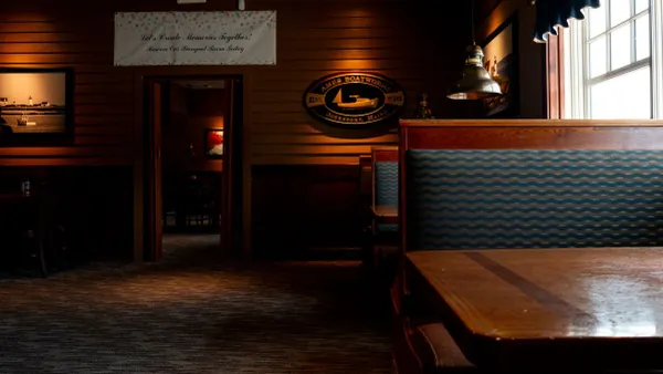 An image of a darkened Red Lobster with empthy booths.