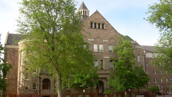 Sprawling brick building with chapel-style tower.