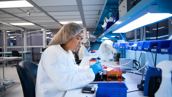 a tech works in a pharma lab