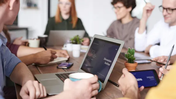 Young professionals collaborating on a presentation in an office setting.