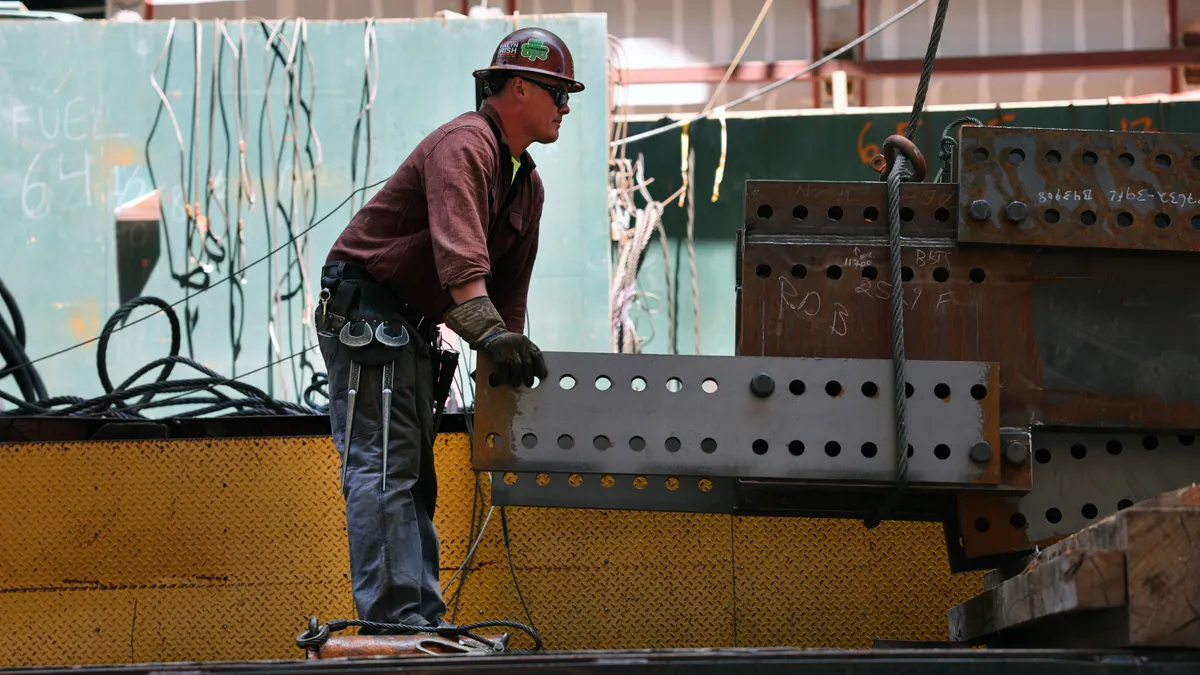 Construction workers prepare steel for a crane at the site of JPMorgan Chase's new headquarters