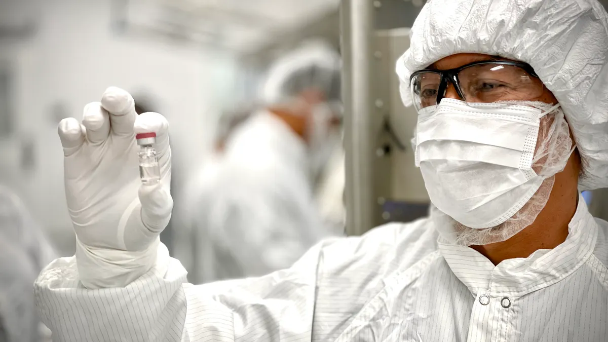 Scientist observing vial