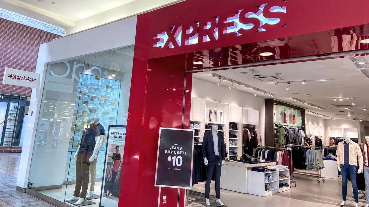 A bright red facade features a cut-out of the word "Express" at a mall store entrance.