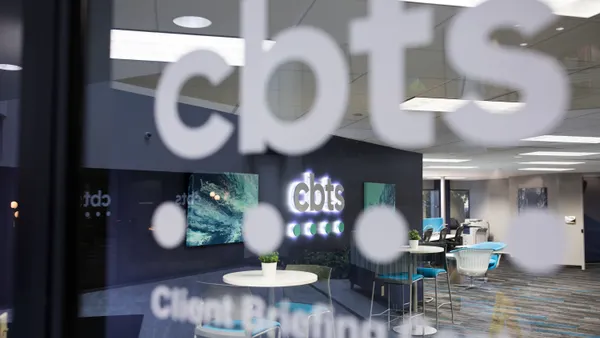 An interior office window with the CBTS company logo printed on it.