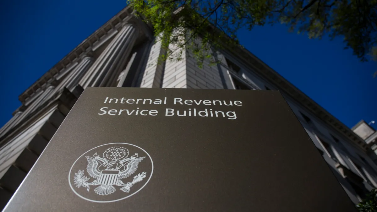 A sign that says "Internal Revenue Service Building" is seen in front of the agency's building.