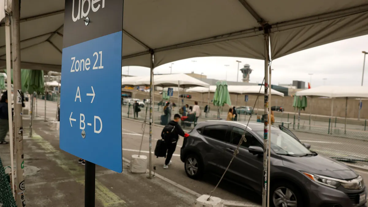 Uber customer gets into a car at Los Angeles International Airport on March 10, 2026