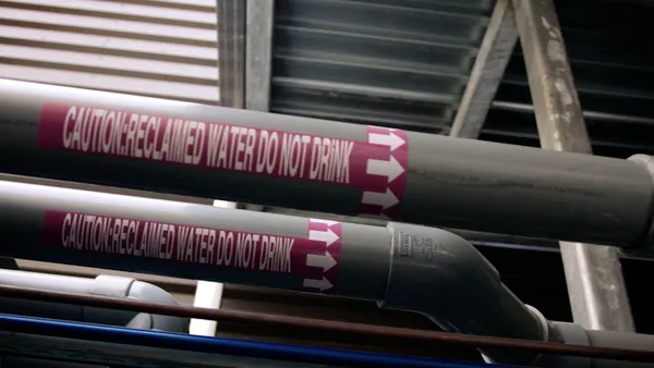 An image of two pipes that say "Caution: Reclaimed Water Do Not Drink"