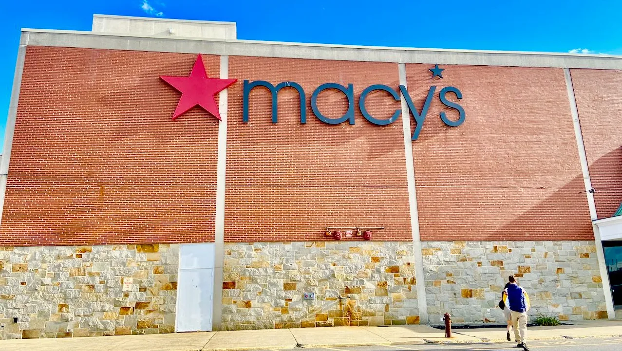 People walking toward a Macy's store.