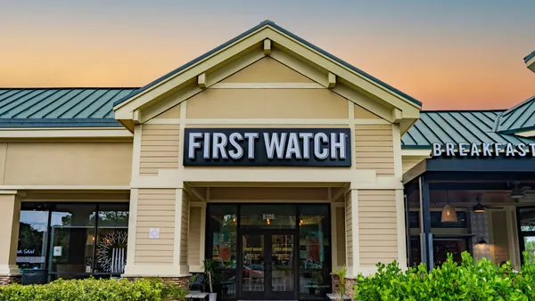 An image of a white building with First Watch signage