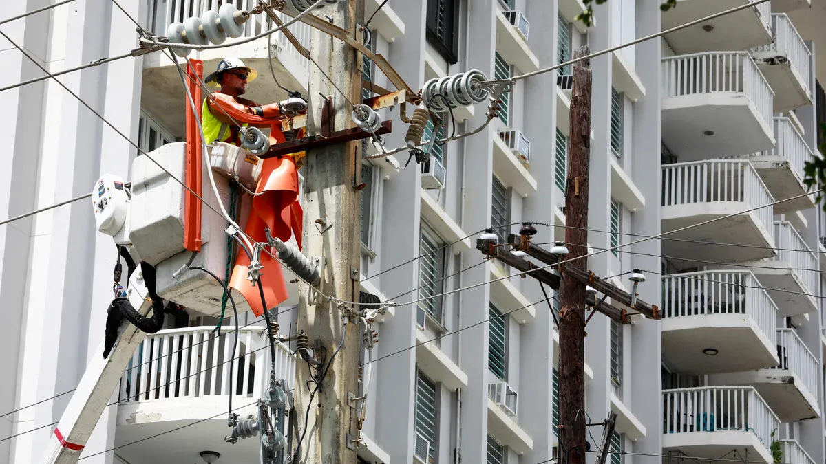 Members of a brigade of the company LUMA work restoring energy on September 20, 2022 in San Juan, Puerto Rico.