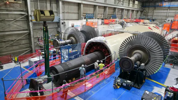 Crews reinstall a 183-ton turbine rotor at the Palisades power plant.