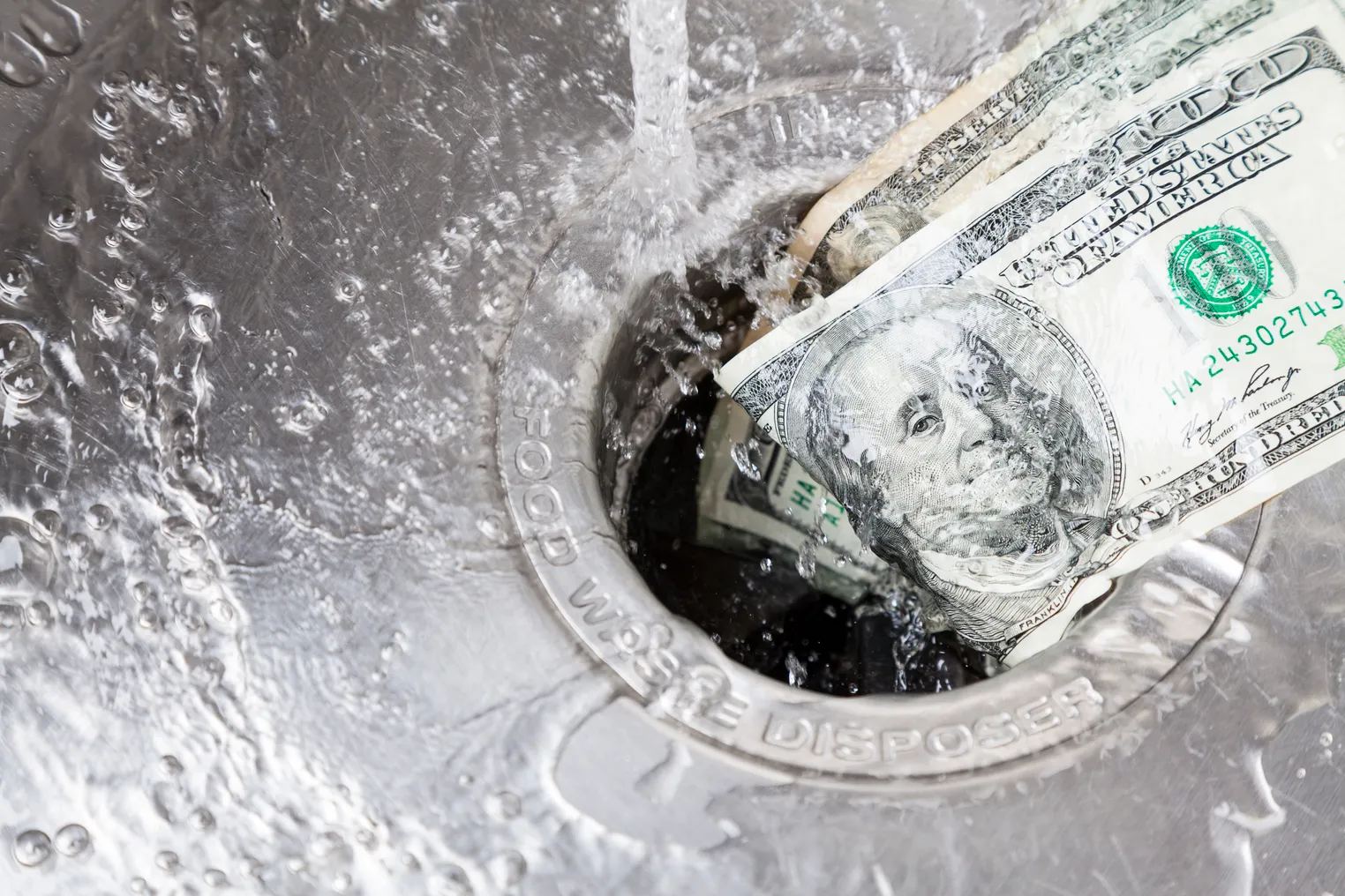 Money being washed down garbage disposal.