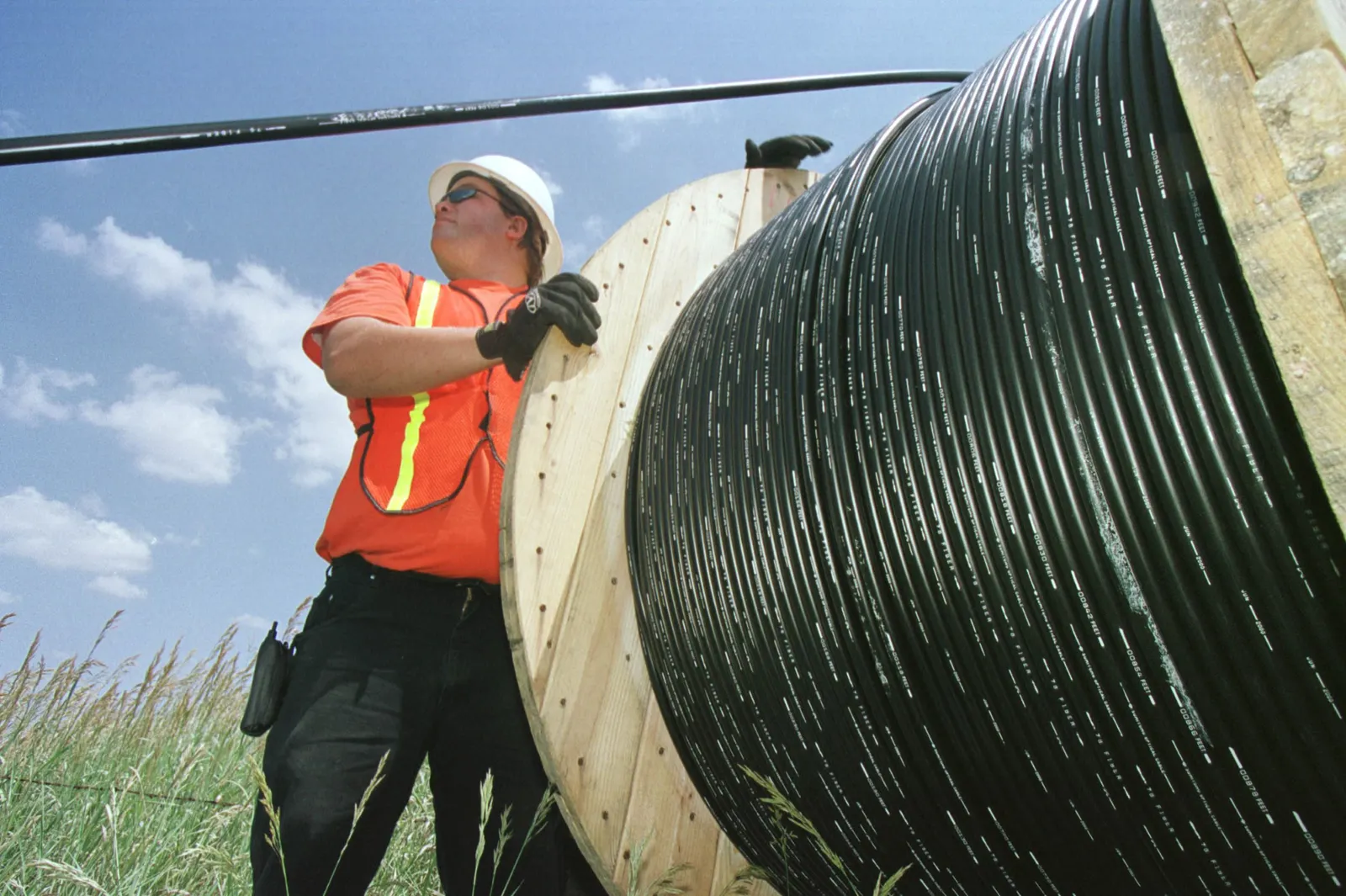 Worker installs fiber-optic cable.