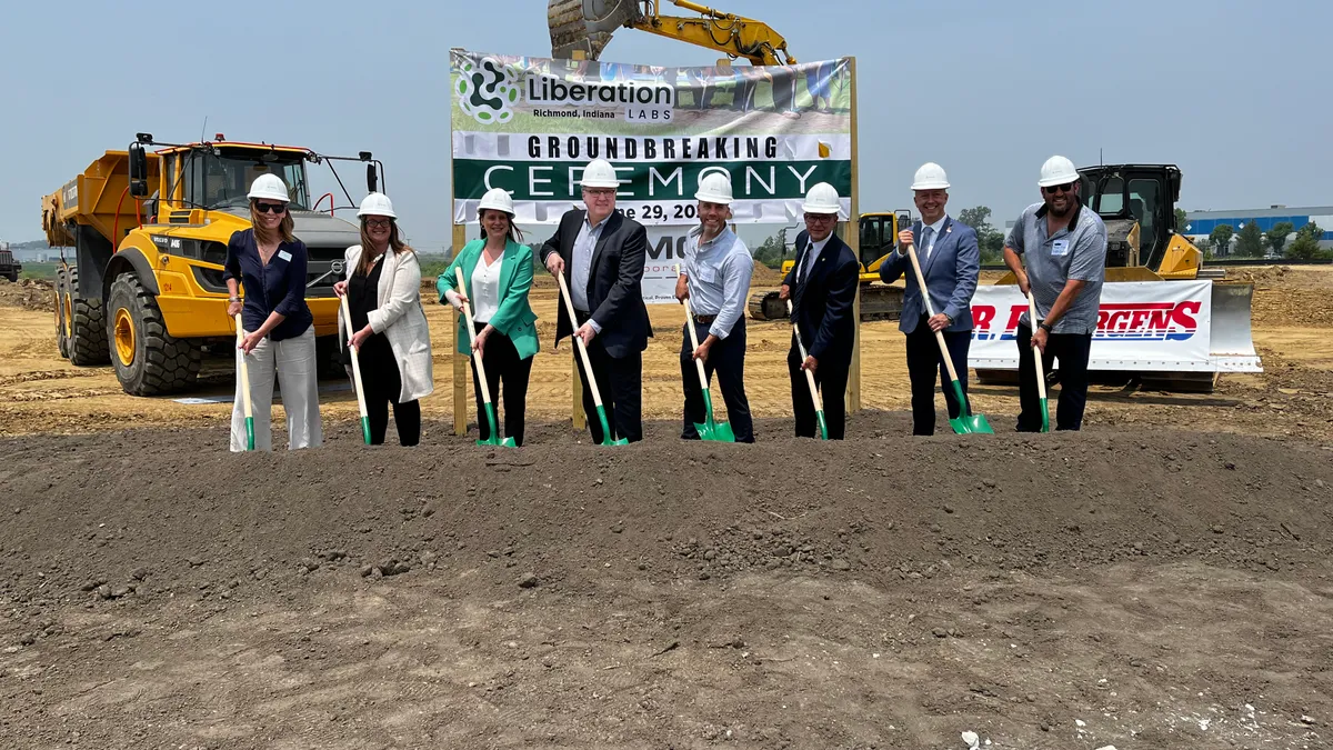 Officials pose with shovels at the site of Liberation Lab's first precision fermentation plant.