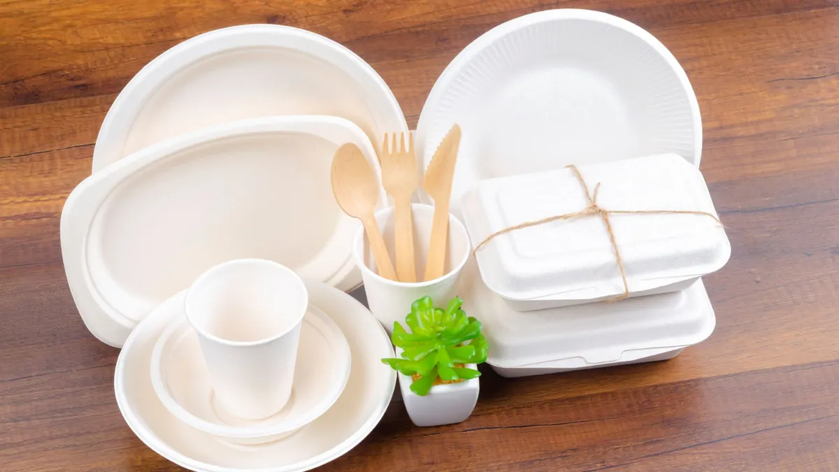 A variety of molded fiber food service ware products, including bowls and trays.